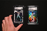 A sports card is placed in the industry-leading CGC holder during the encapsulation step of the CGC grading process.