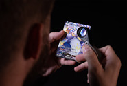 A CGC grader examines a sports card during the grading stage of the CGC certification process.