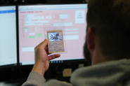 A CGC verifier assigns an ID and barcode to a sports card during the verification step of the CGC grading process.